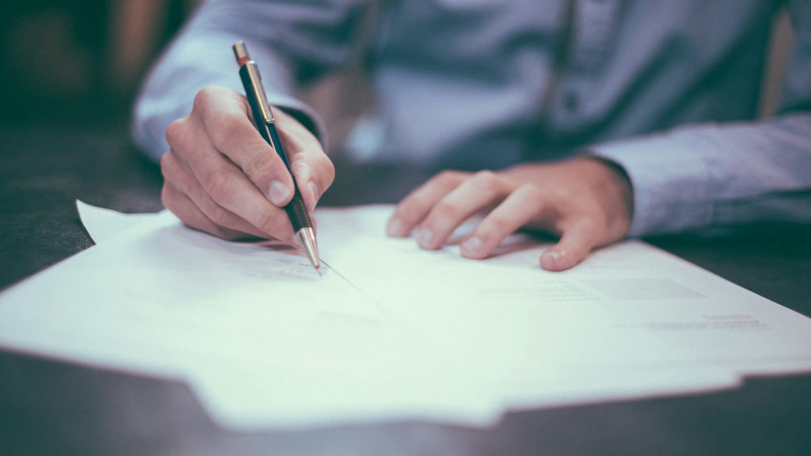 Homeowners insurance claim paperwork and a pen on a desk